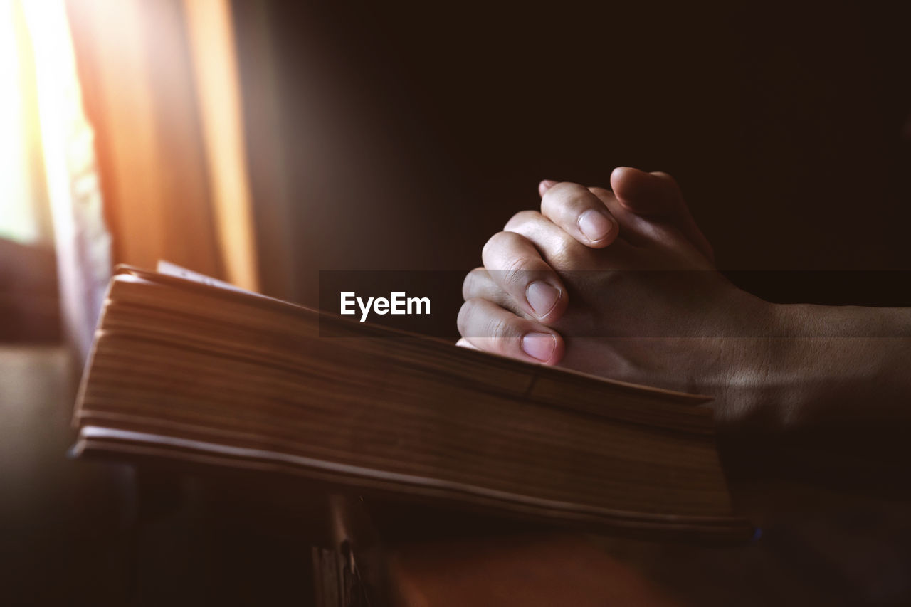 Close-up of hand with book