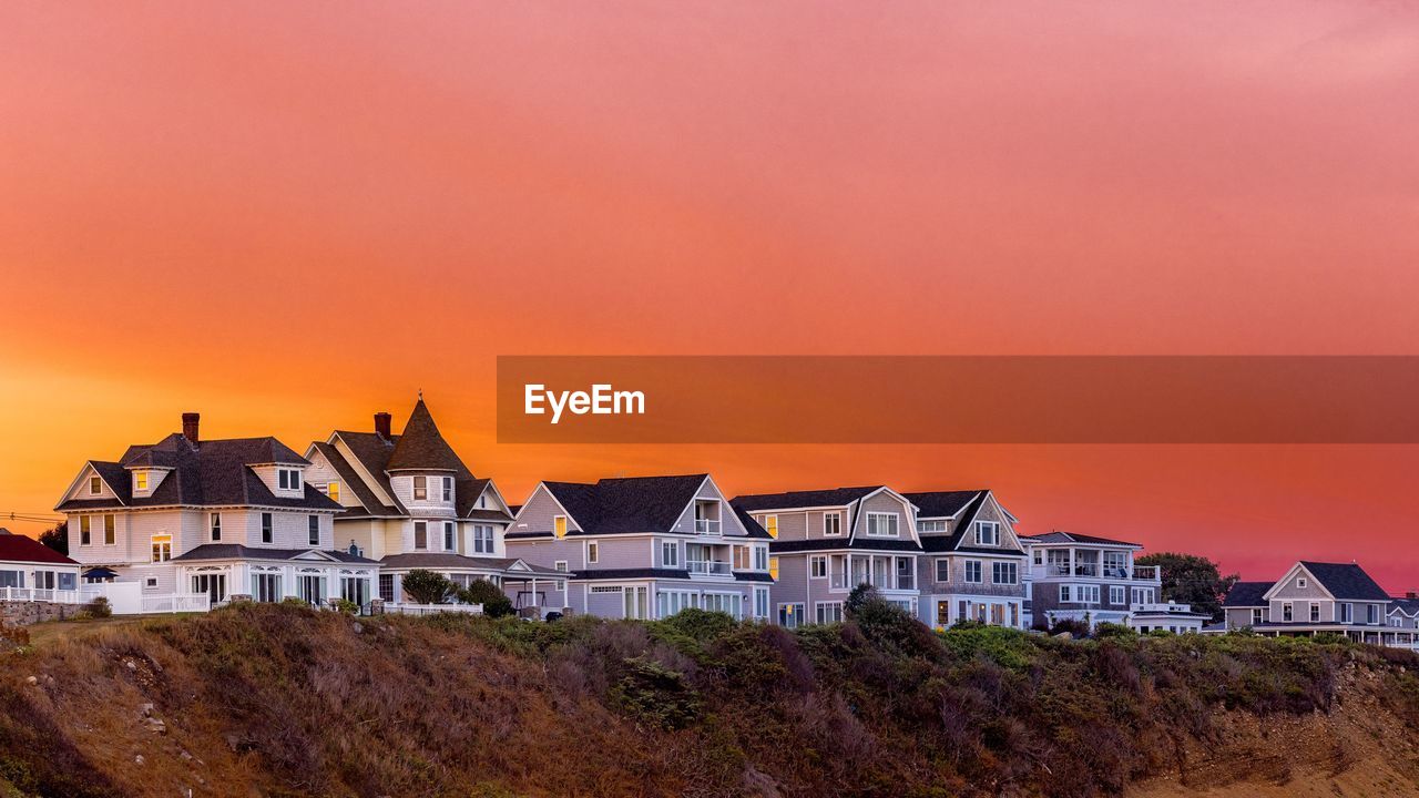 Seaside homes with a brilliant sky during sunset