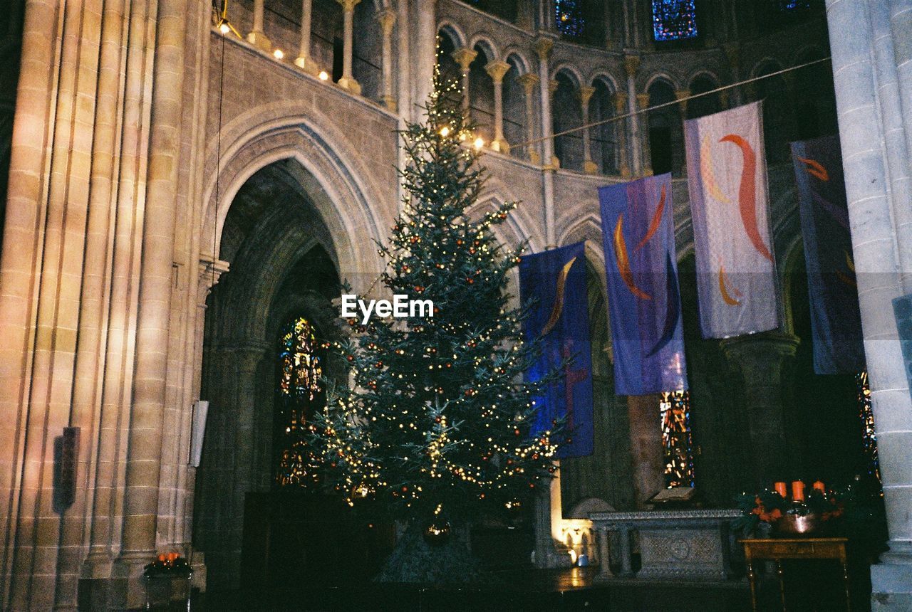 LOW ANGLE VIEW OF ILLUMINATED LIGHTING EQUIPMENT AT NIGHT