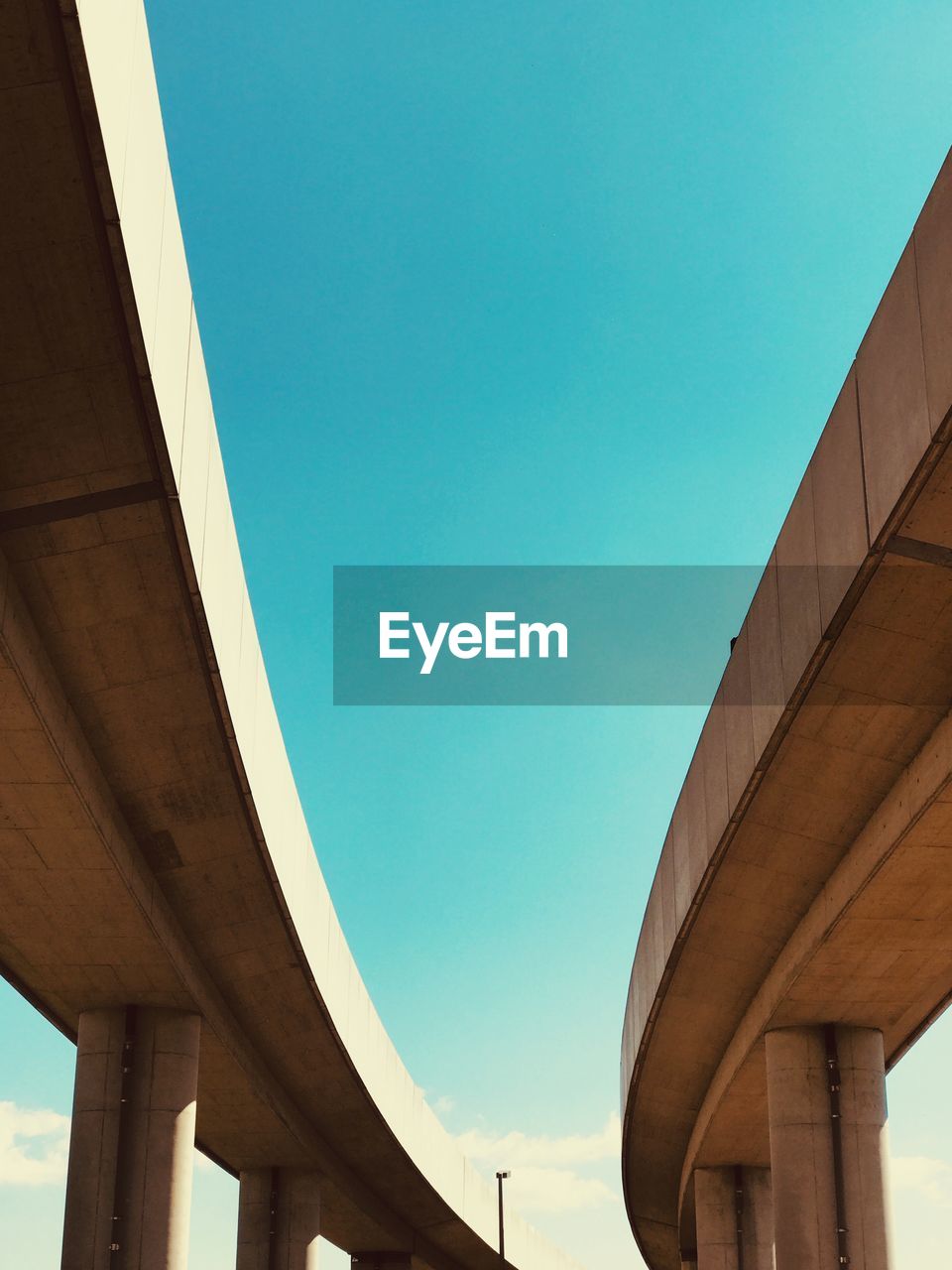LOW ANGLE VIEW OF ELEVATED ROAD AGAINST SKY
