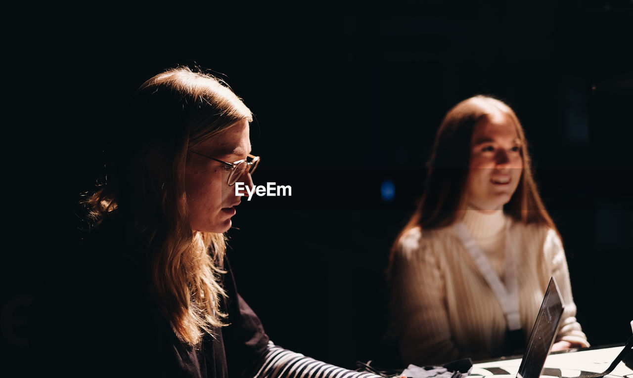 Young women sitting indoors