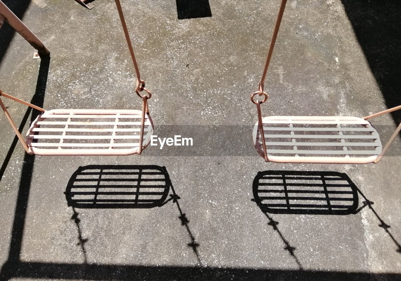 High angle view of swings hanging in playground