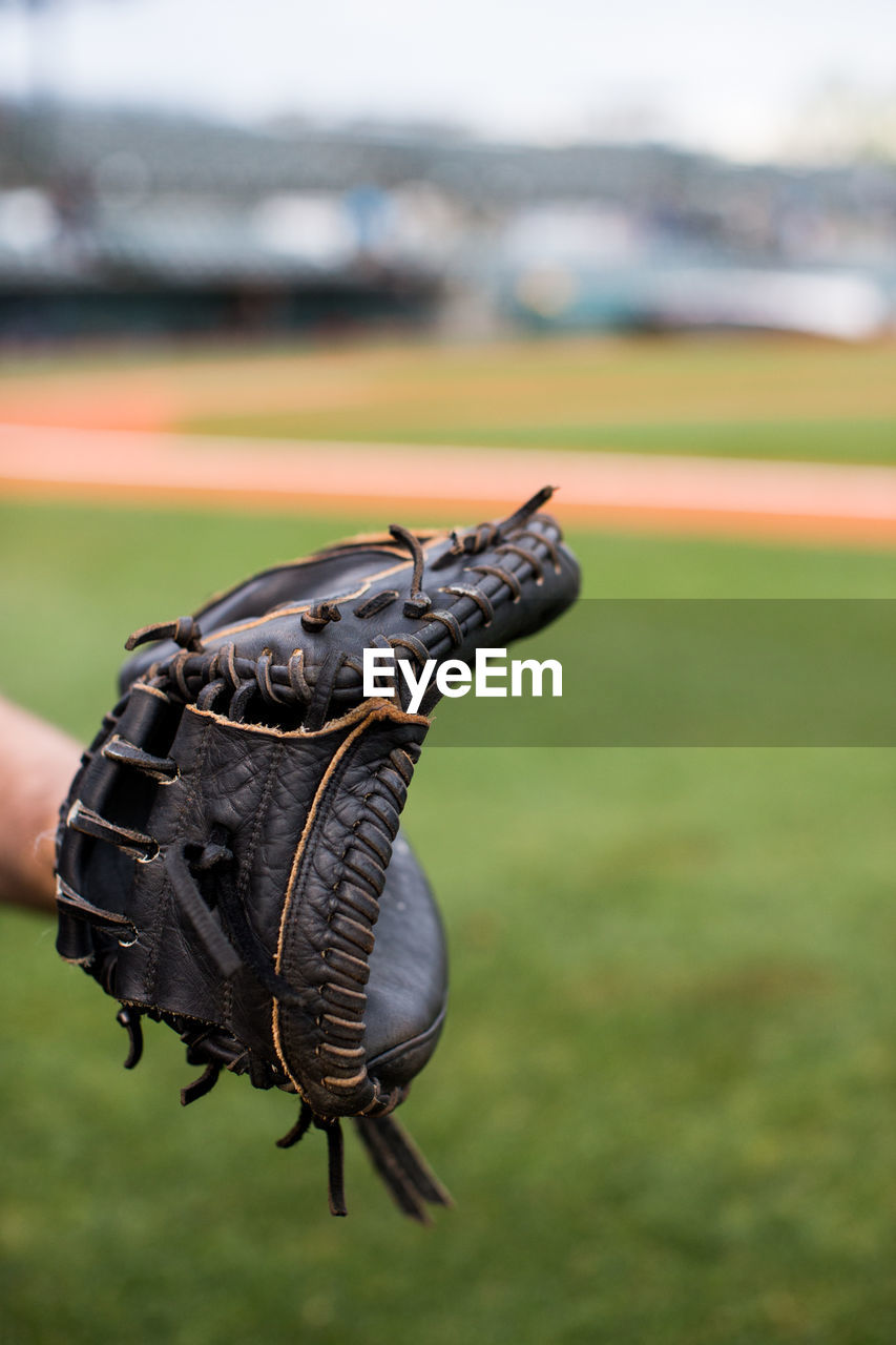 Close-up of baseball glove on field