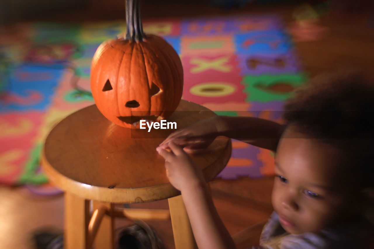 Close-up of cute girl with jack o lantern