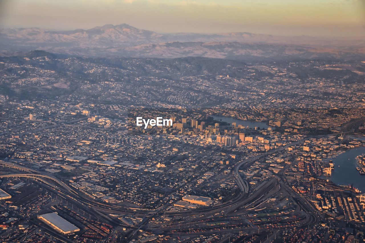 aerial photography, city, horizon, aerial view, architecture, cityscape, building exterior, sky, landscape, built structure, dusk, nature, environment, building, evening, high angle view, no people, travel destinations, sunset, cloud, outdoors, residential district, scenics - nature, urban skyline, transportation, city life, mountain, travel, bird's-eye view, night, business finance and industry, reflection, land, beauty in nature, skyline