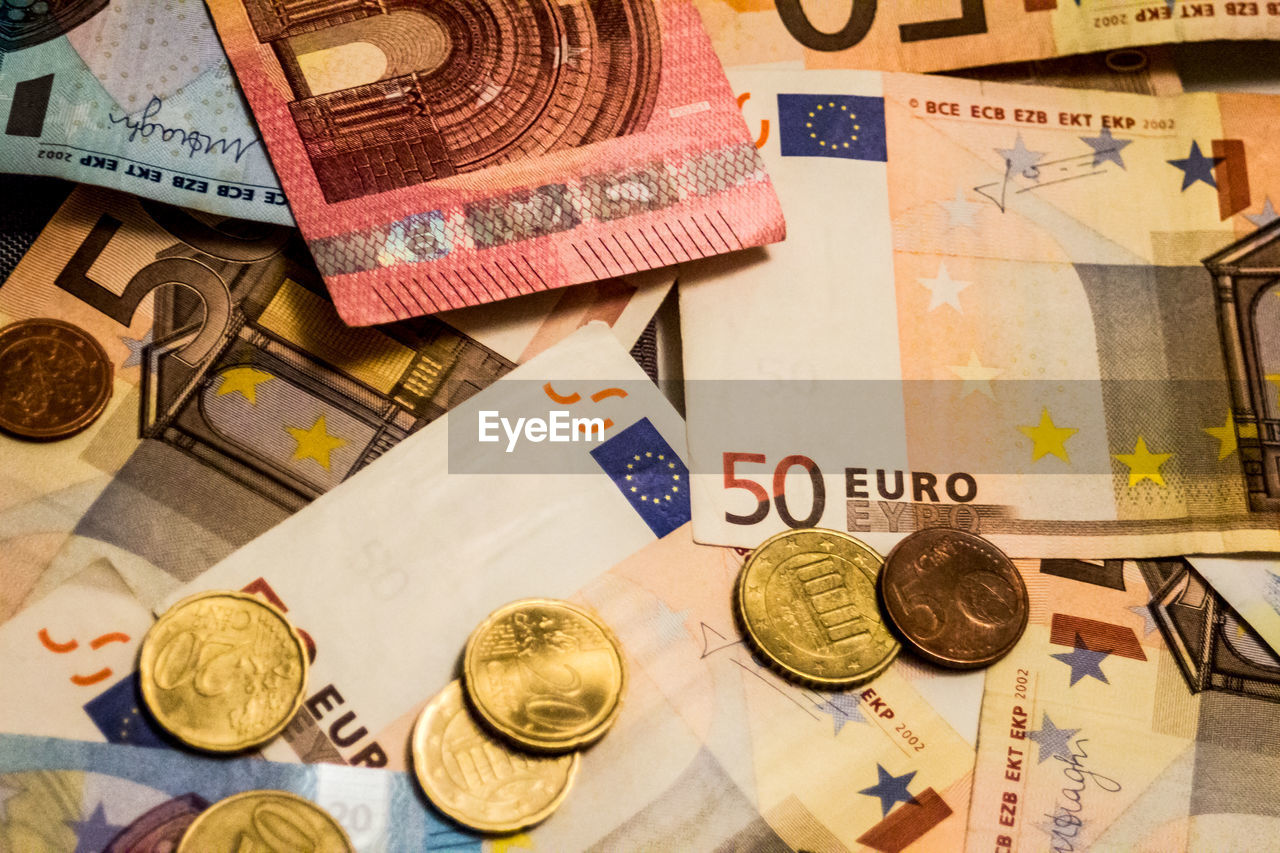 A composition of euro banknotes and coins. eu, eur