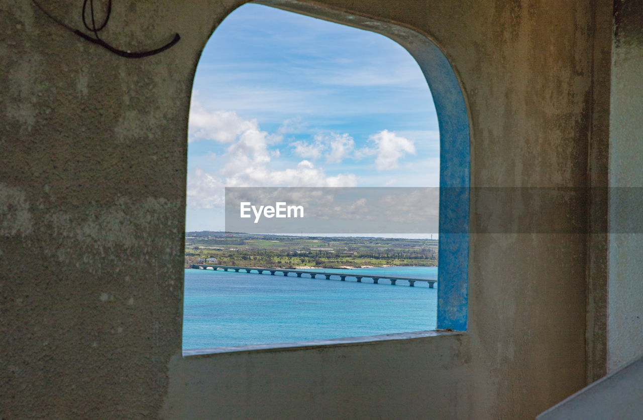 Scenic view of sea against sky seen through window