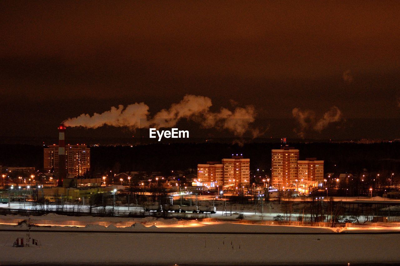 ILLUMINATED CITYSCAPE AGAINST SKY AT NIGHT