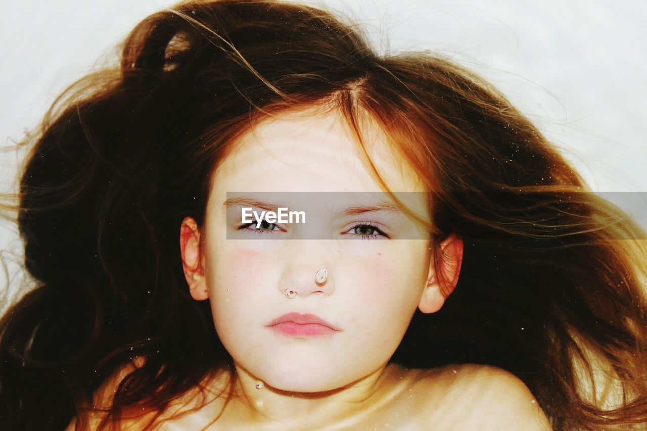 Close-up portrait of girl in bathtub