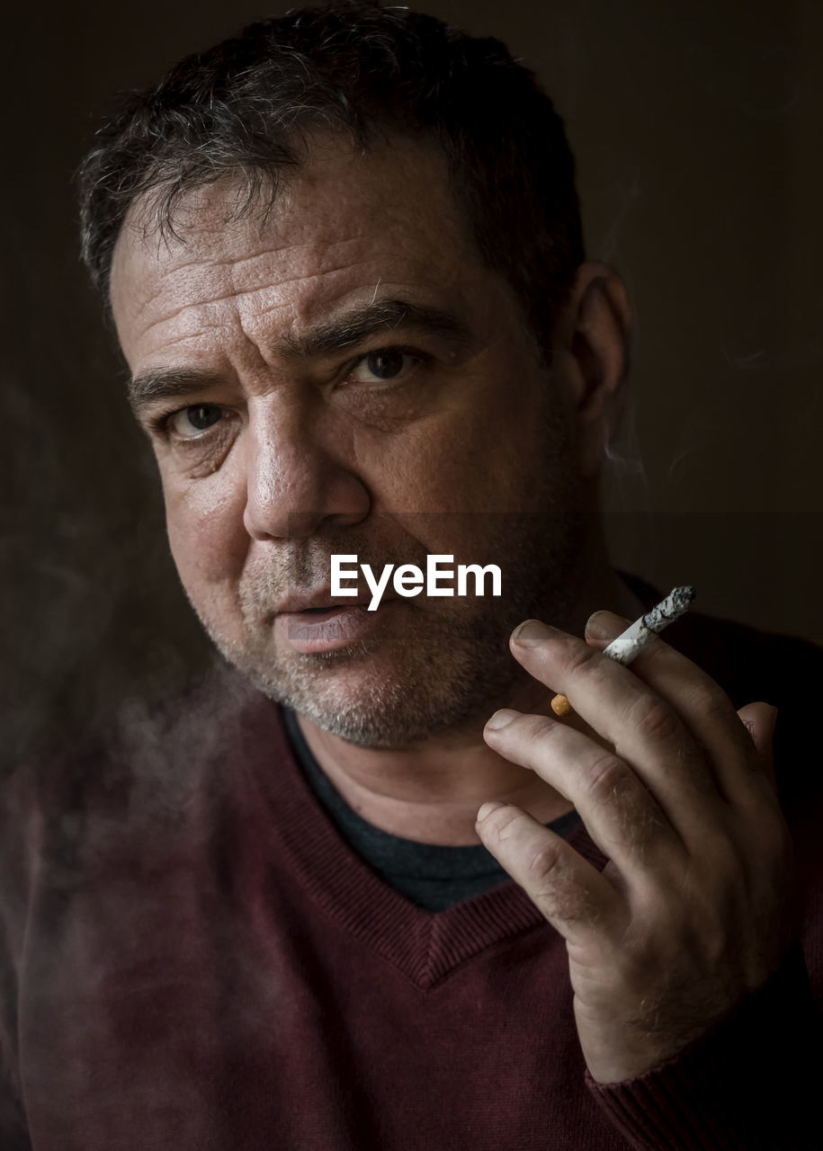 Mature man smokes a cigarette