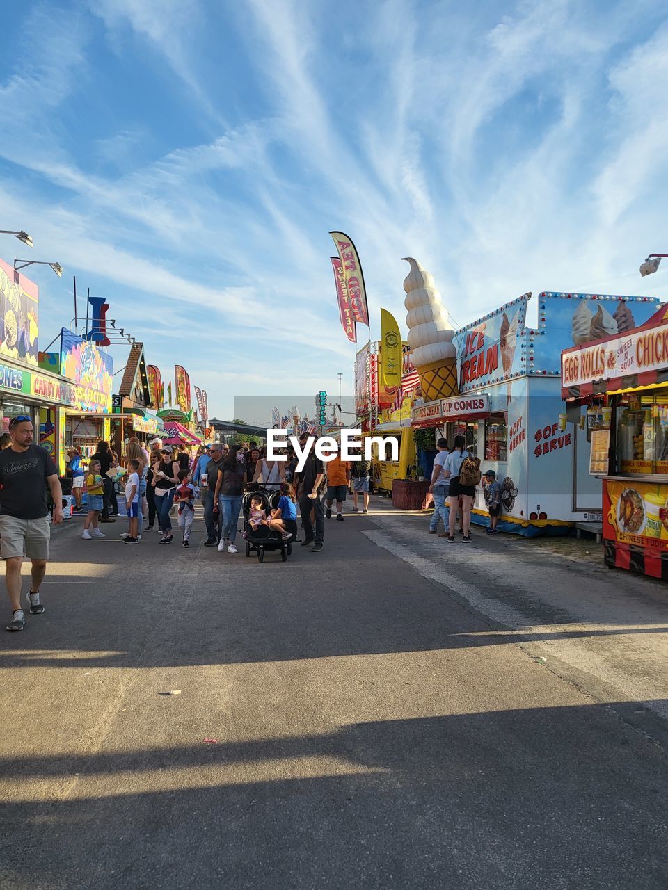 architecture, built structure, nature, blue, day, group of people, sky, high angle view, transportation, outdoors, building exterior, city, crowd, cloud, large group of people, travel destinations, arts culture and entertainment, travel, sunlight, water, amusement park