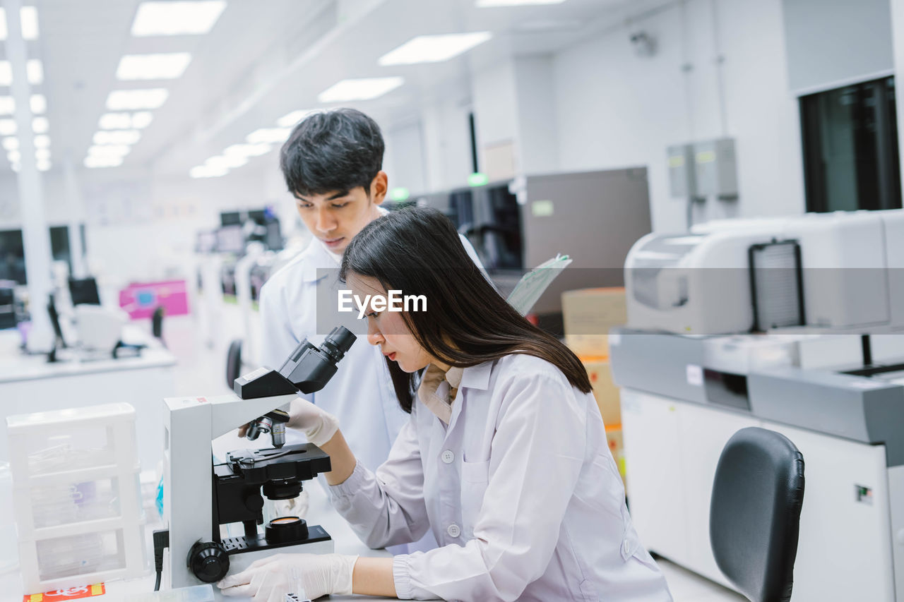 Scientist examining specimen in laboratory