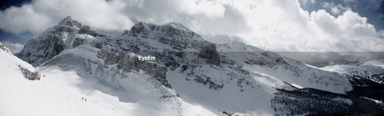 Scenic view of mountains against cloudy sky