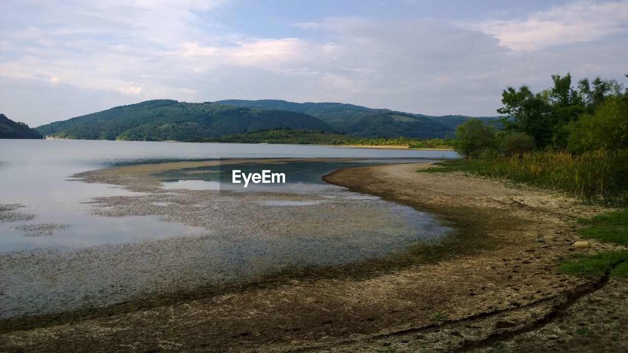 SCENIC VIEW OF LANDSCAPE BY MOUNTAINS AGAINST SKY