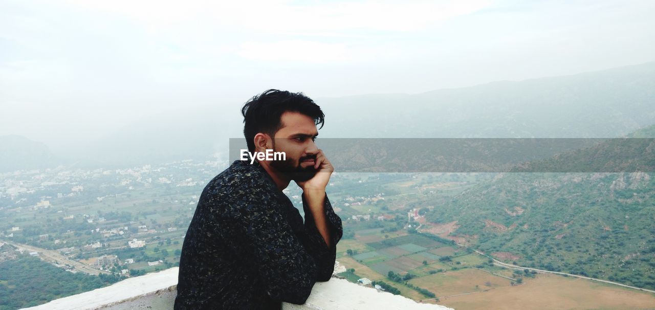 Young man looking at mountains