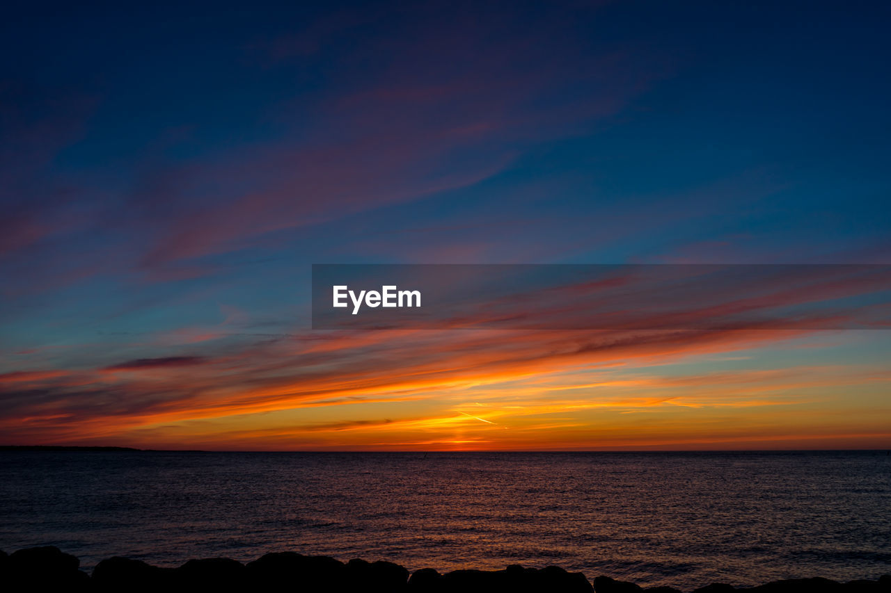 Scenic view of sea against sky during sunset