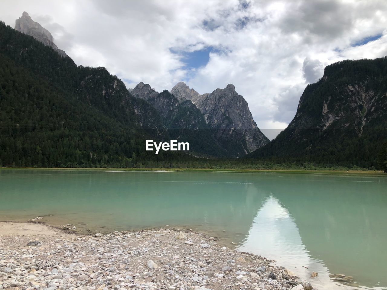 Scenic view of lake and mountains against sky