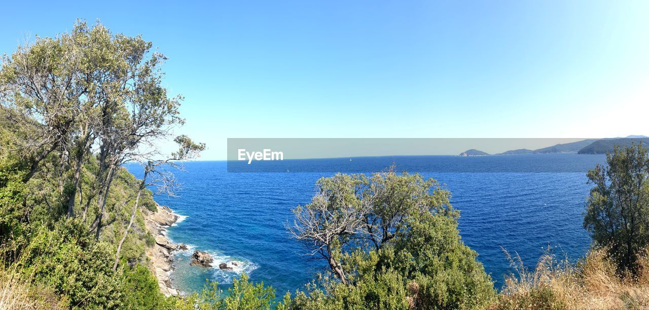 Scenic view of sea against clear blue sky