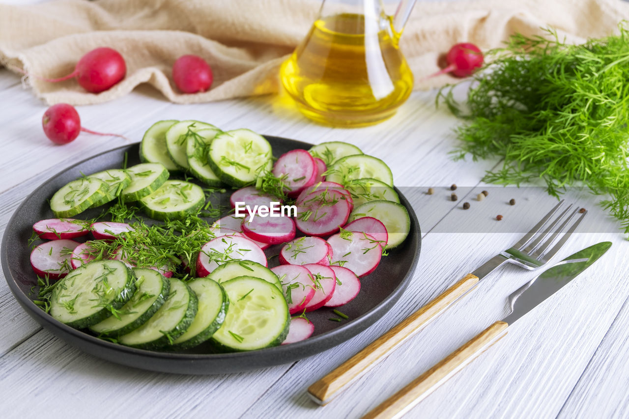 Fresh cucumber and radish salad with dill and vegetable oil. vegetarian diet. 