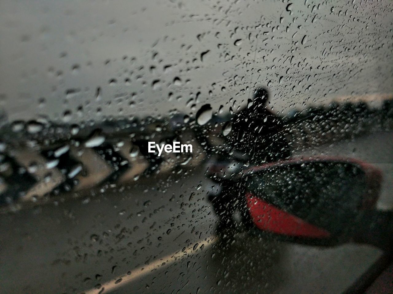 CLOSE-UP OF WET CAR WINDOW AGAINST SKY