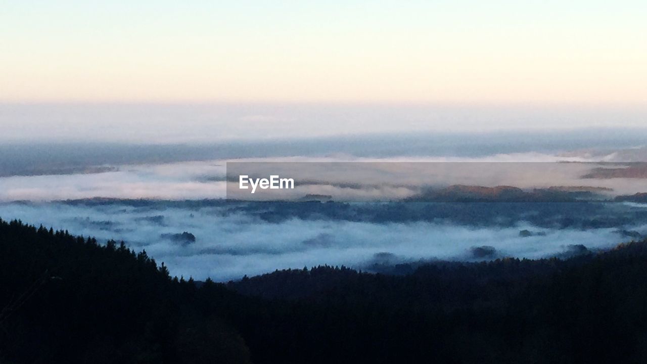 SCENIC VIEW OF MOUNTAINS AGAINST CLOUDY SKY