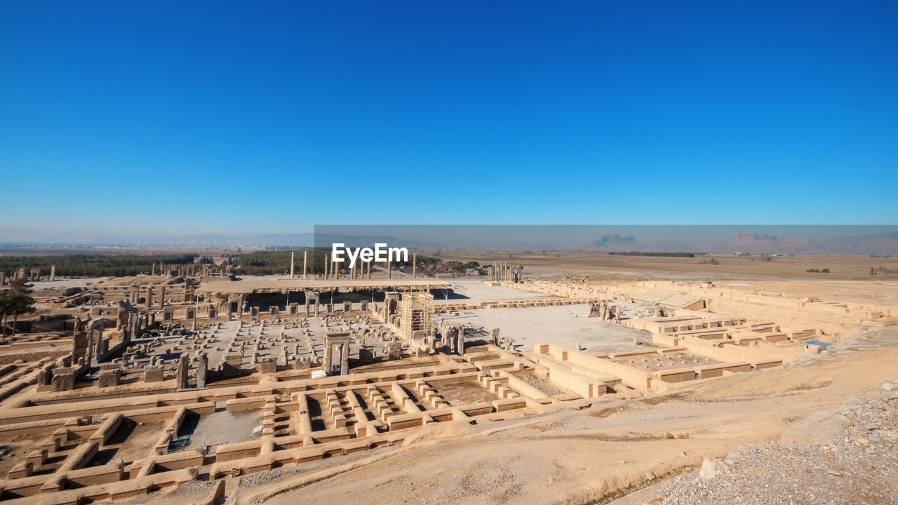 Aerial view of persepolis, ancient capital of persian empire against blue sky