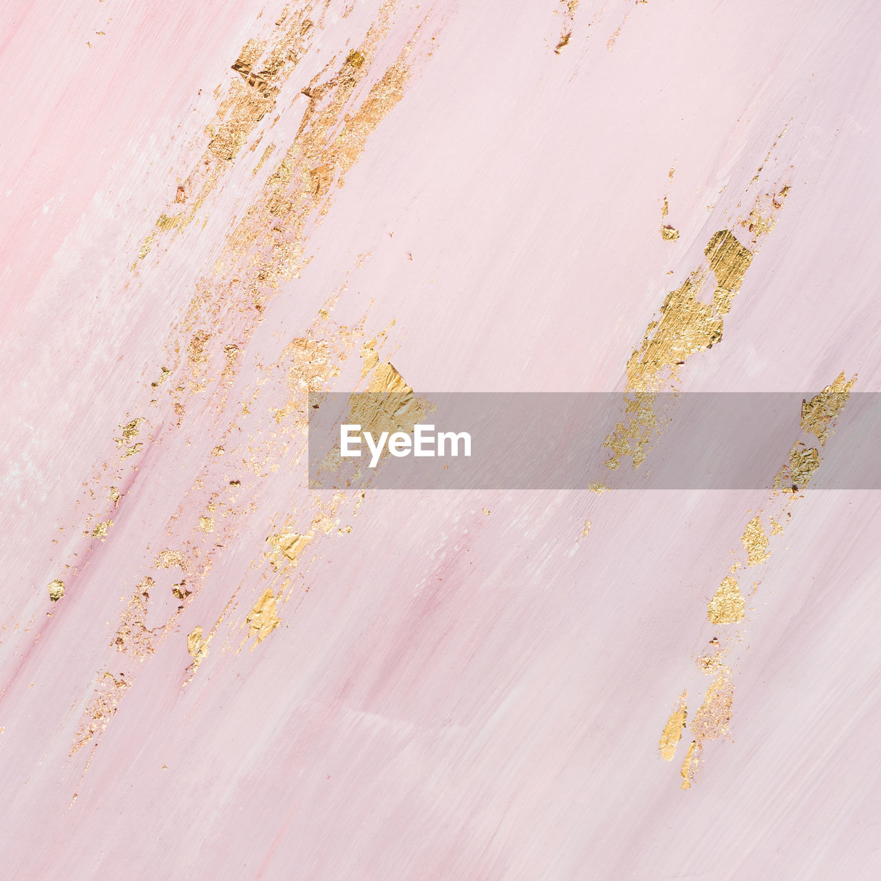 Delicate pink marble background with gold brushstrokes. place for your design.