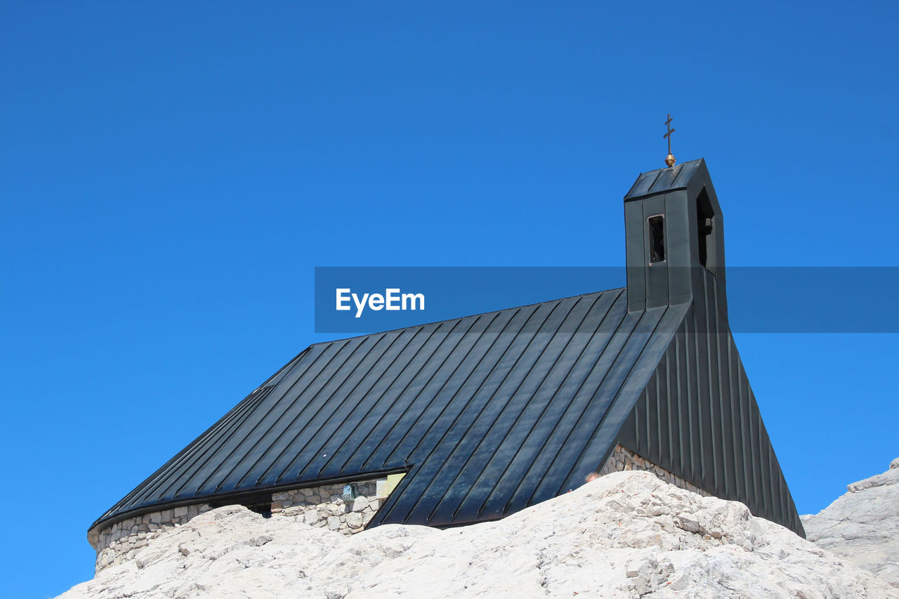 Low angle view of building against clear blue sky