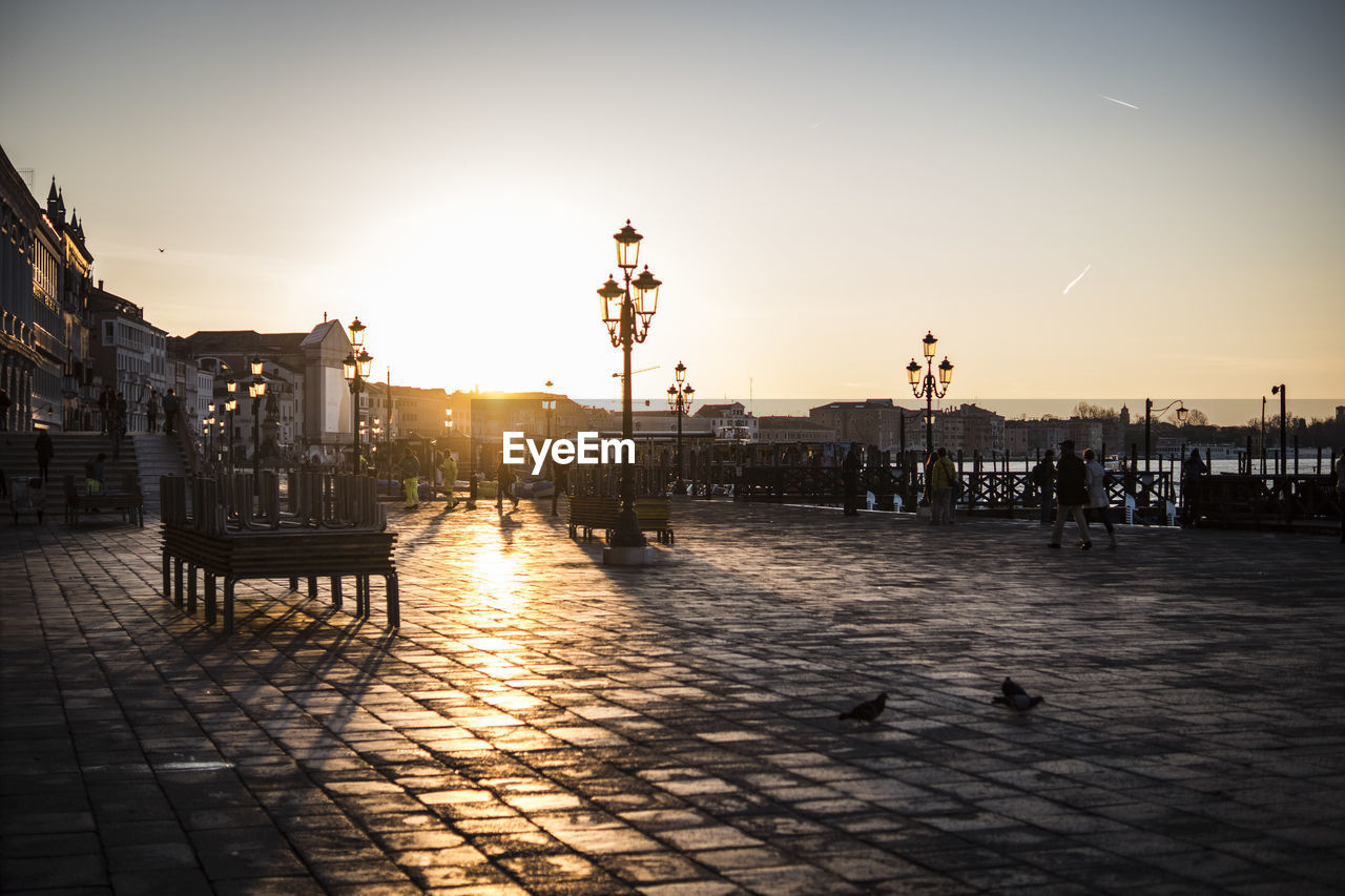 Tourist at st marks square against sky during sunset