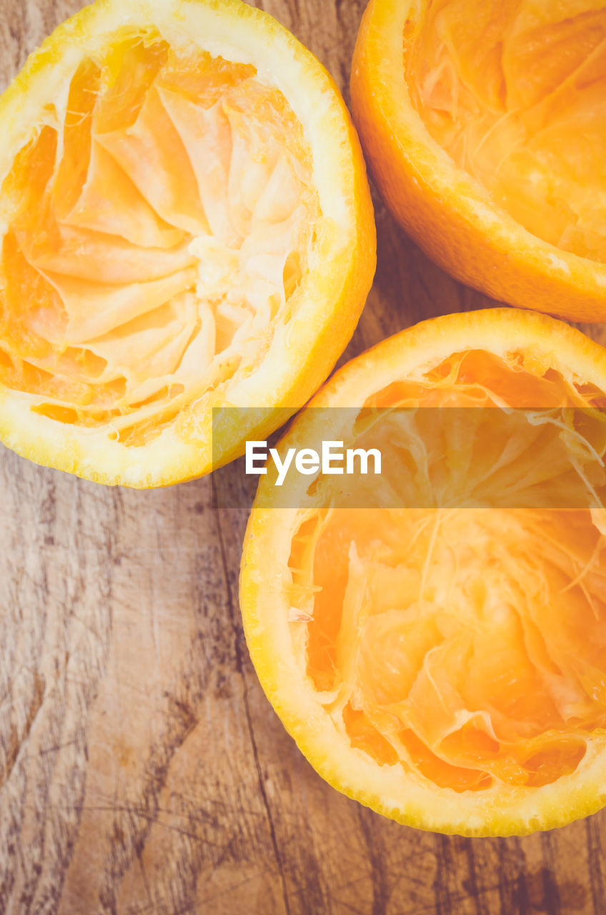 High angle view of squeezed oranges on table