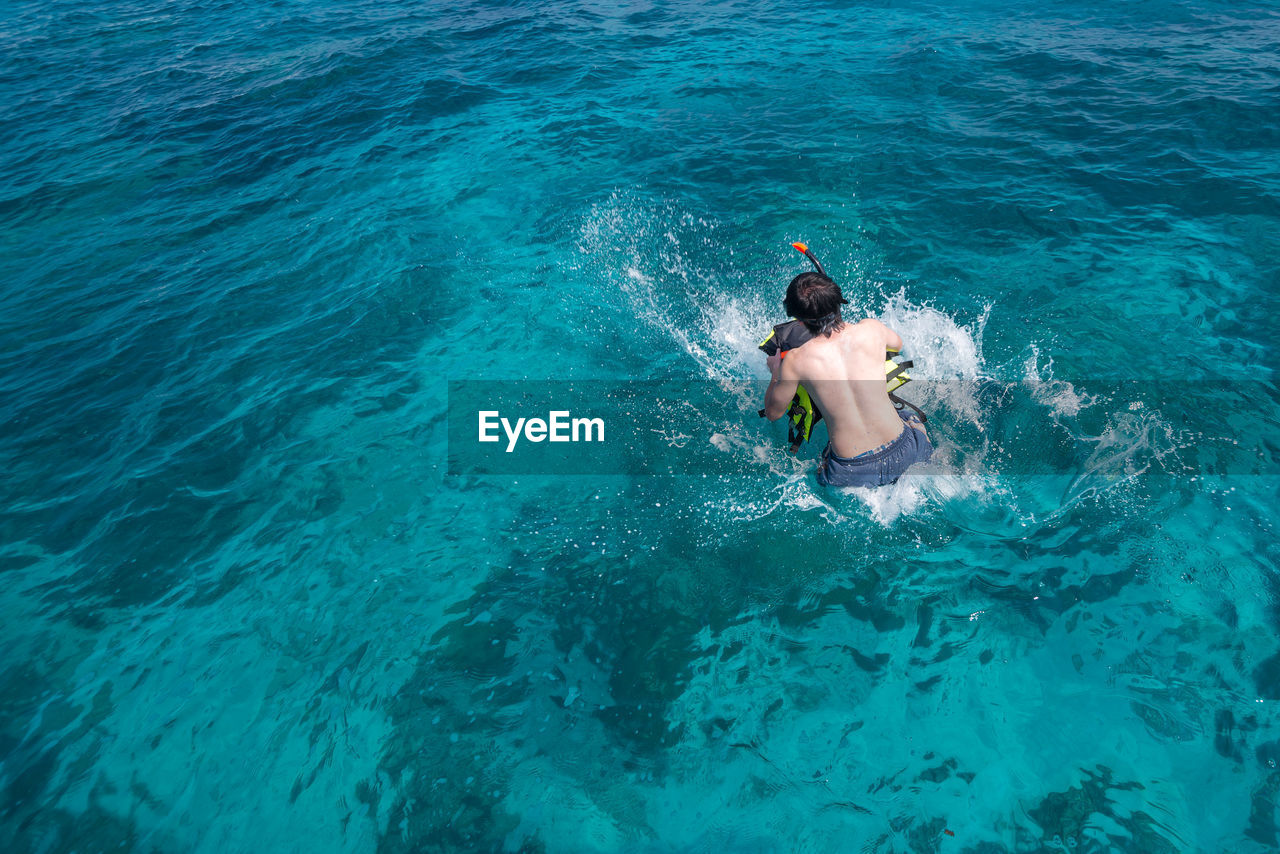 HIGH ANGLE VIEW OF WOMAN IN SEA