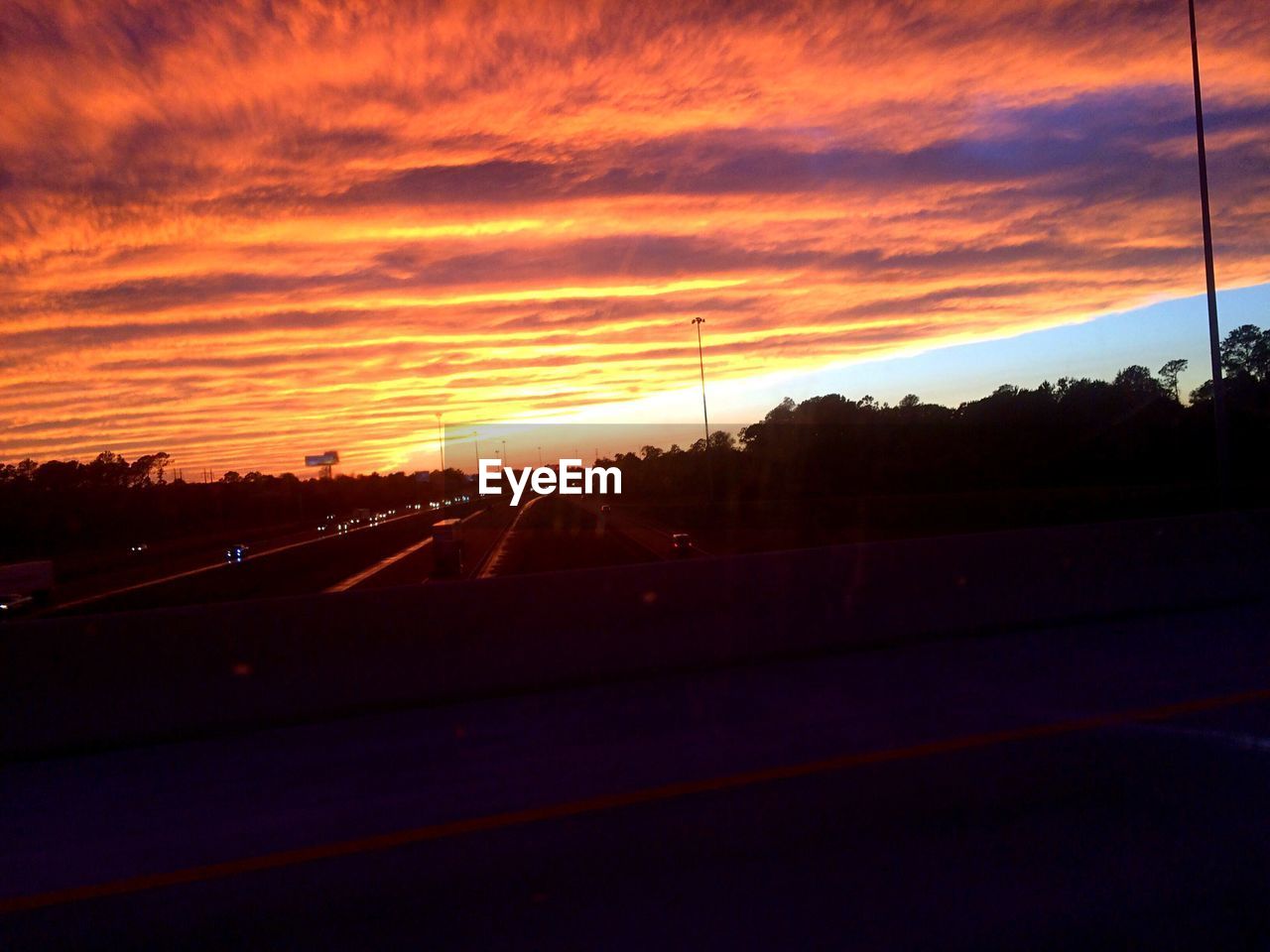 VIEW OF ROAD AGAINST CLOUDY SKY DURING SUNSET