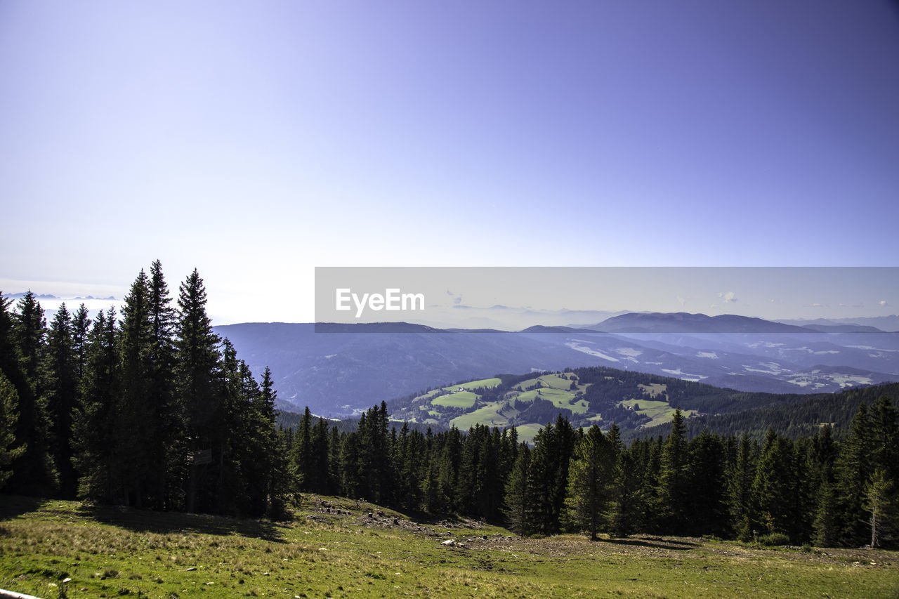 Scenic view of landscape and mountains against clear sky