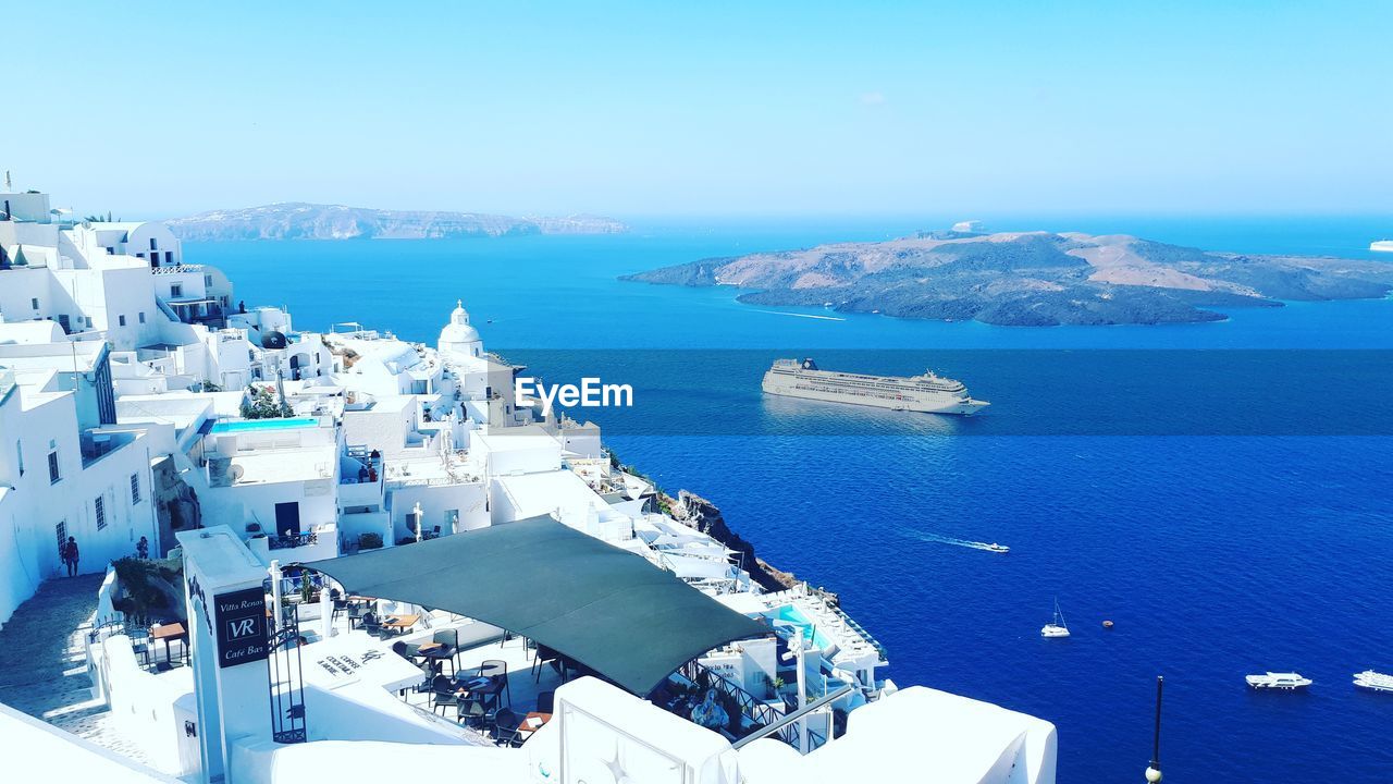 High angle view of sea by buildings against sky