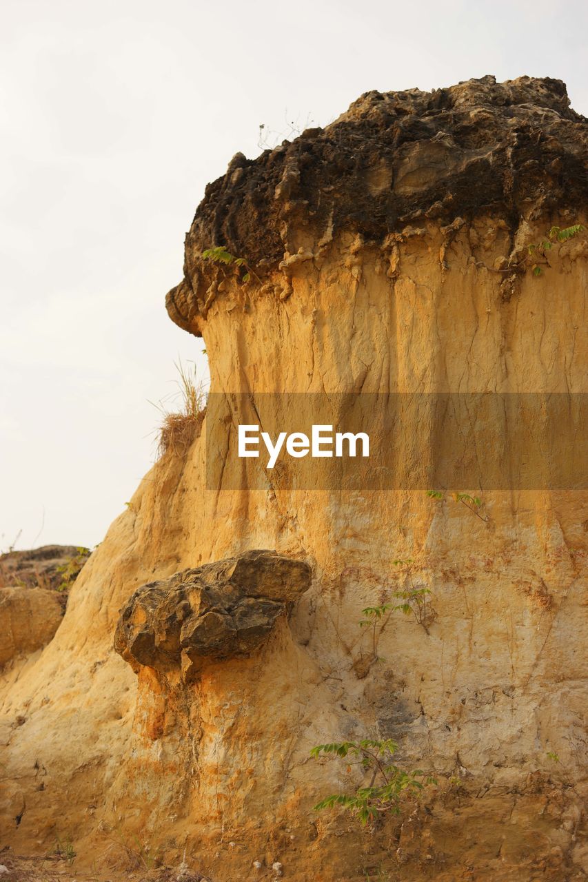 Mushroom-shaped rock formations on mountain against clear sky