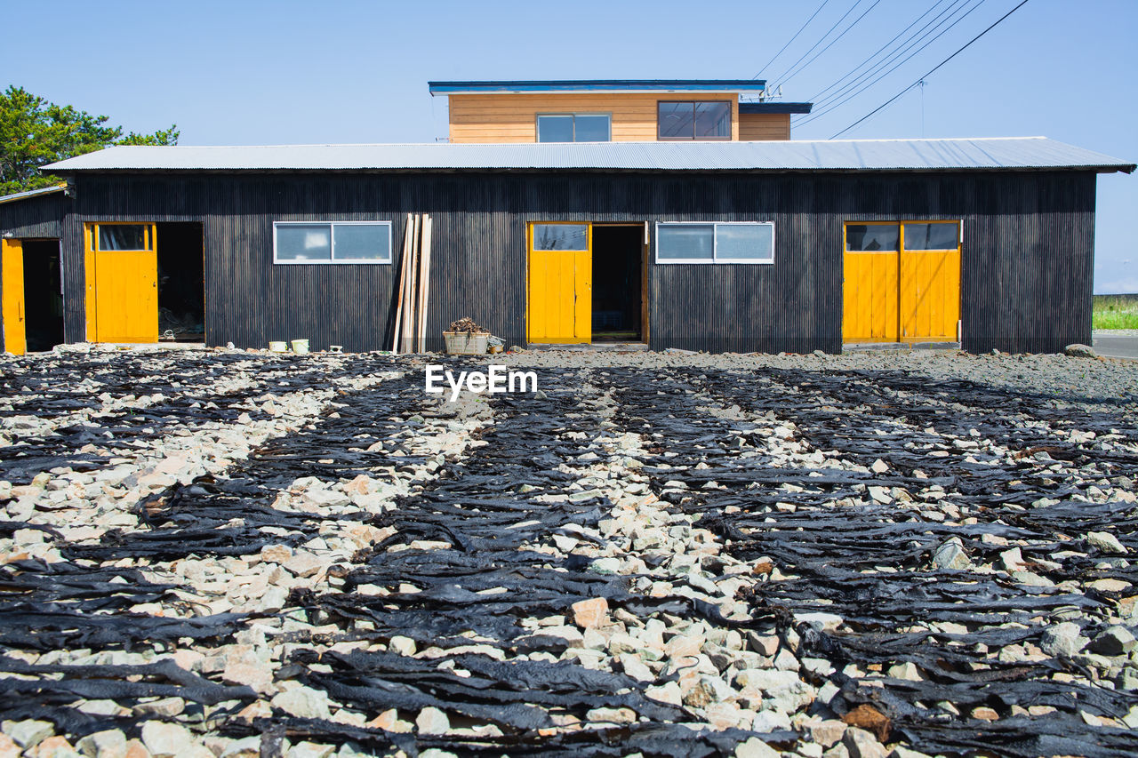 architecture, built structure, building exterior, nature, sky, building, house, no people, day, clear sky, outdoors, gravel, transportation, residential area, facade, sunlight