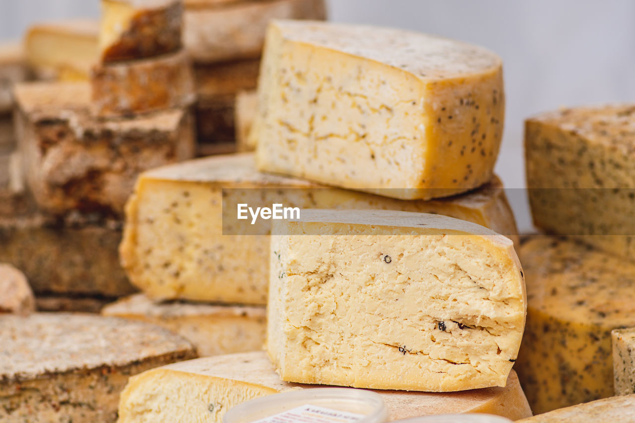 Variety of homemade bio natural seasoned cheese in a street food market ready to eat, close up