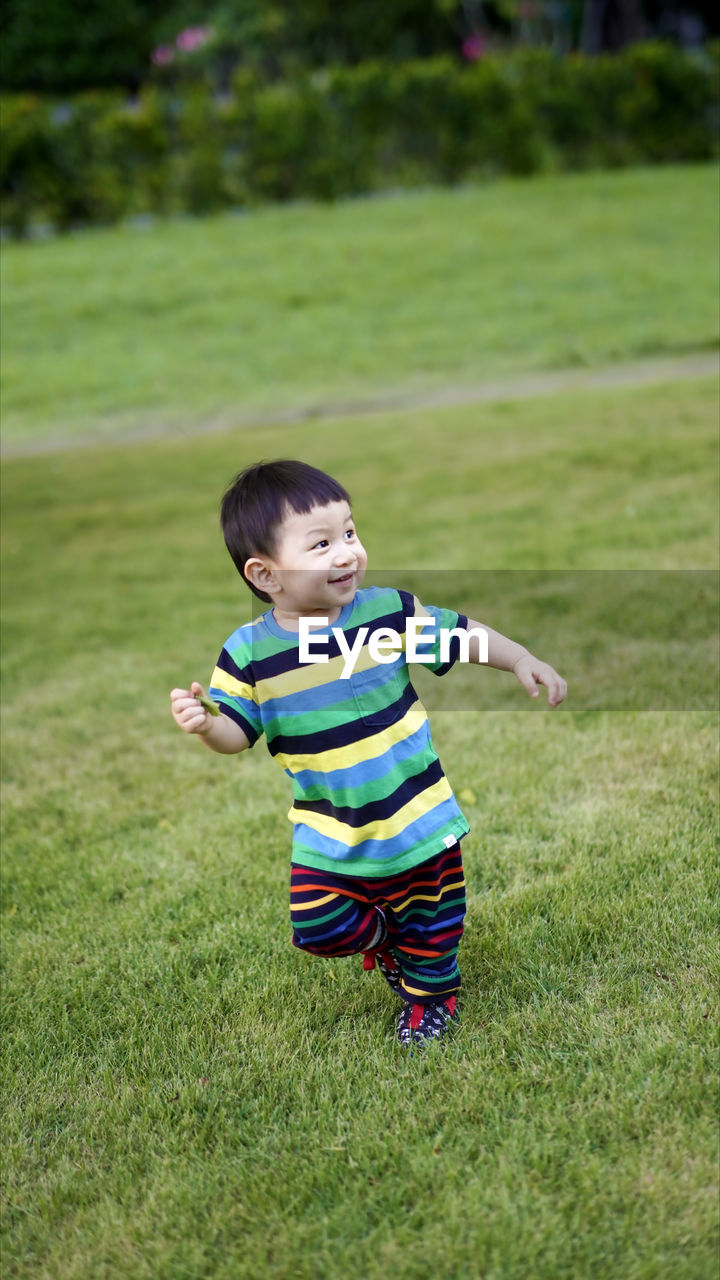 FULL LENGTH OF A BOY ON FIELD