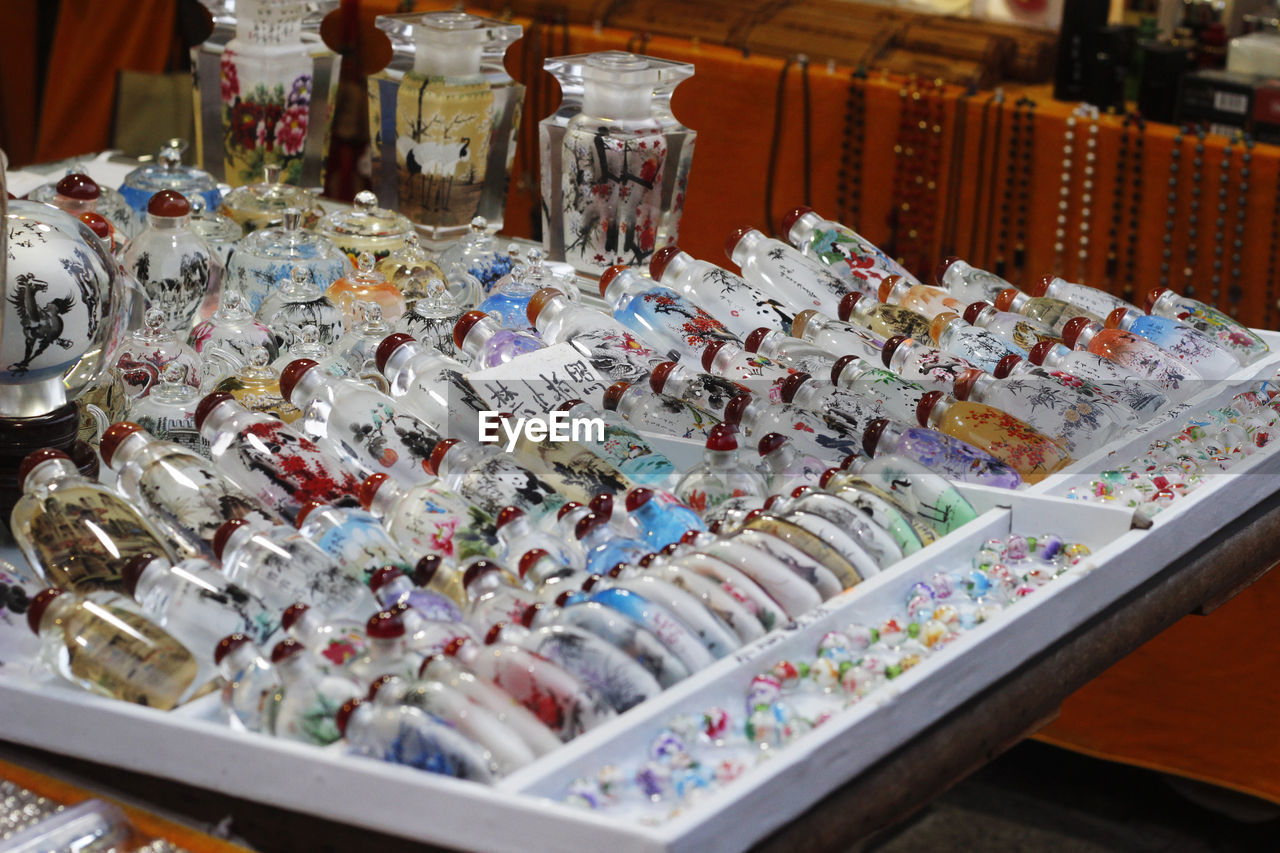 HIGH ANGLE VIEW OF BOTTLES ON TABLE IN MARKET