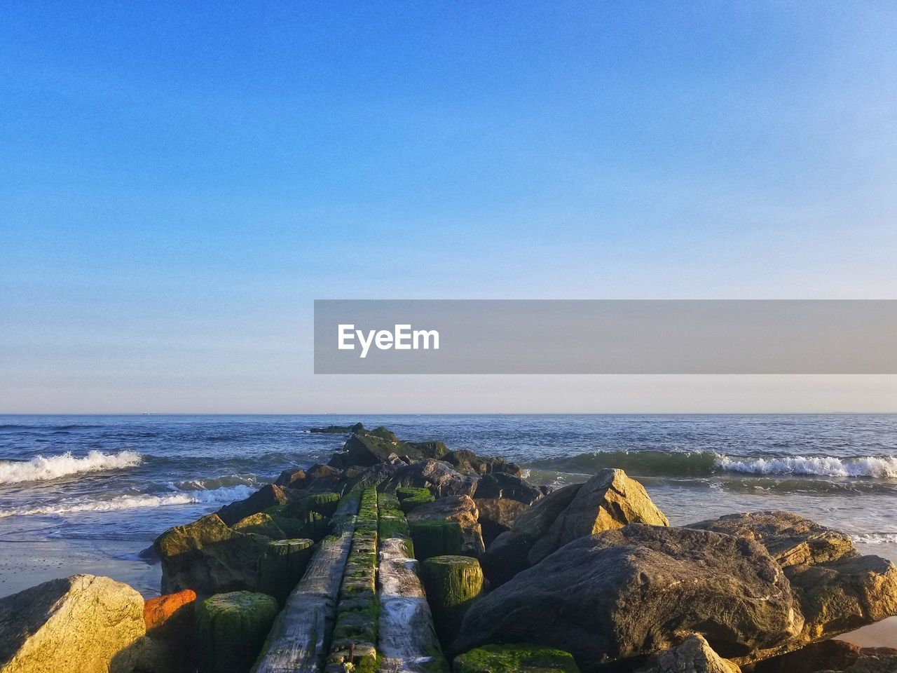 Scenic view of sea against clear blue sky