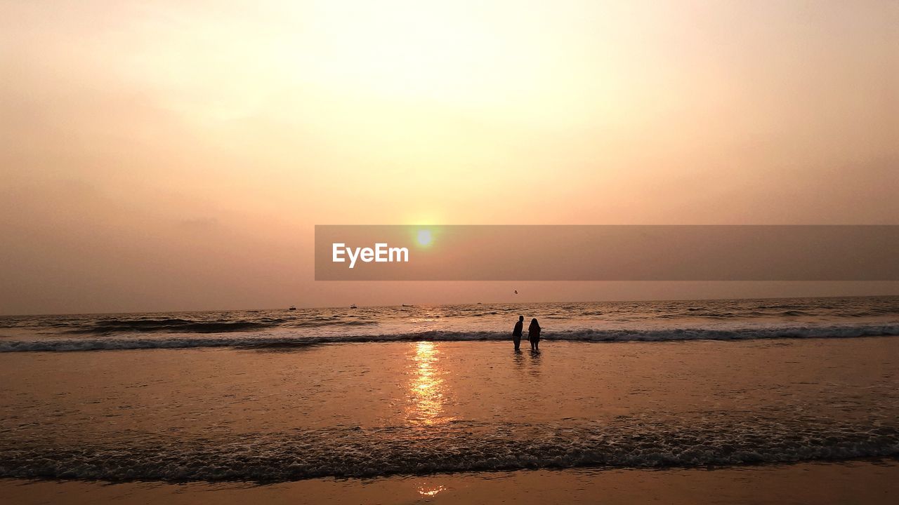 SILHOUETTE PEOPLE ON BEACH DURING SUNSET