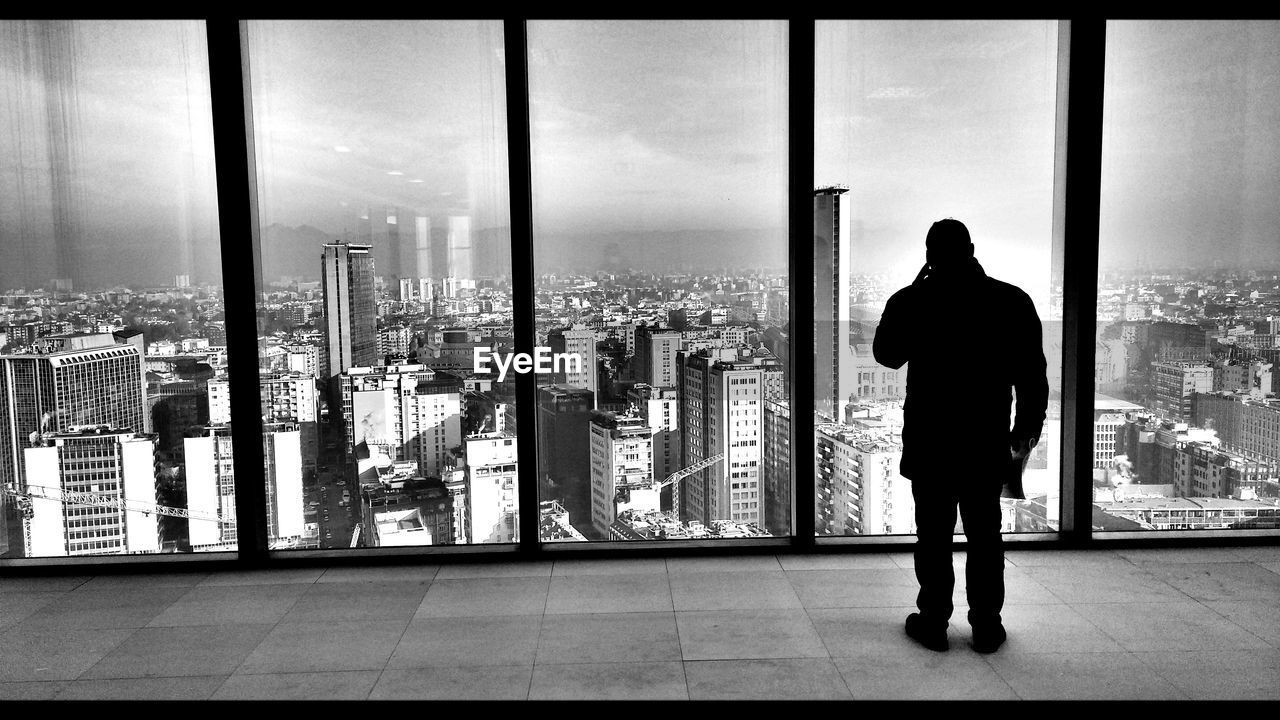 Rear view of man standing in a modern building
