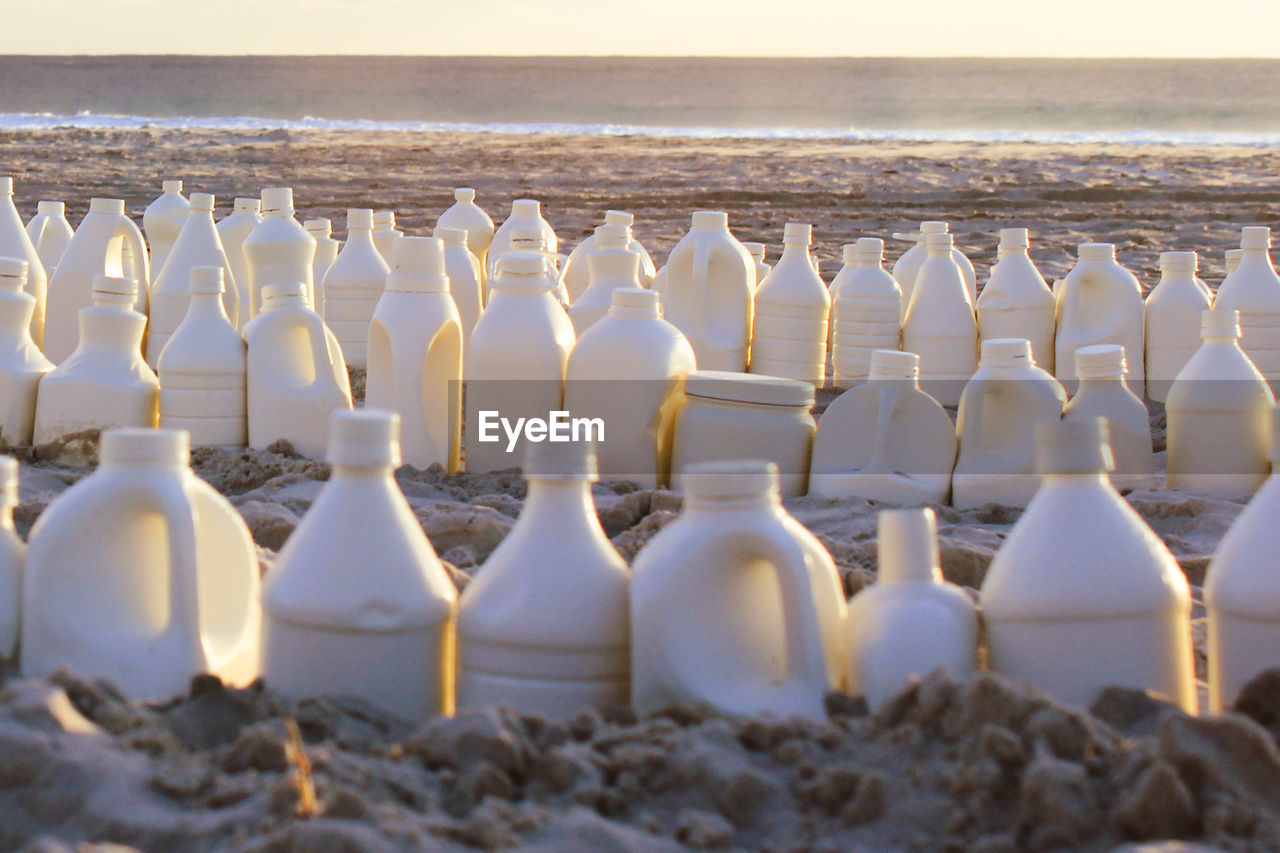 Close-up of bottles on beach