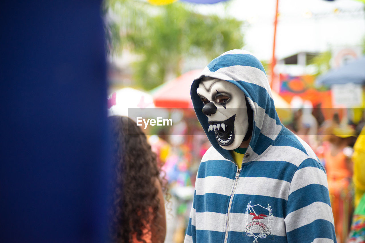 People wearing horror masks are seen playing during the carnival