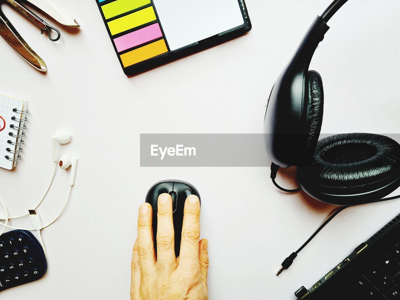 Flat lay of office desk with pc and headphones