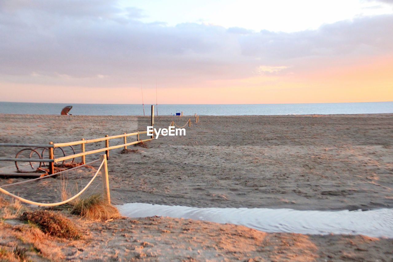 Scenic view of beach against sky during sunset