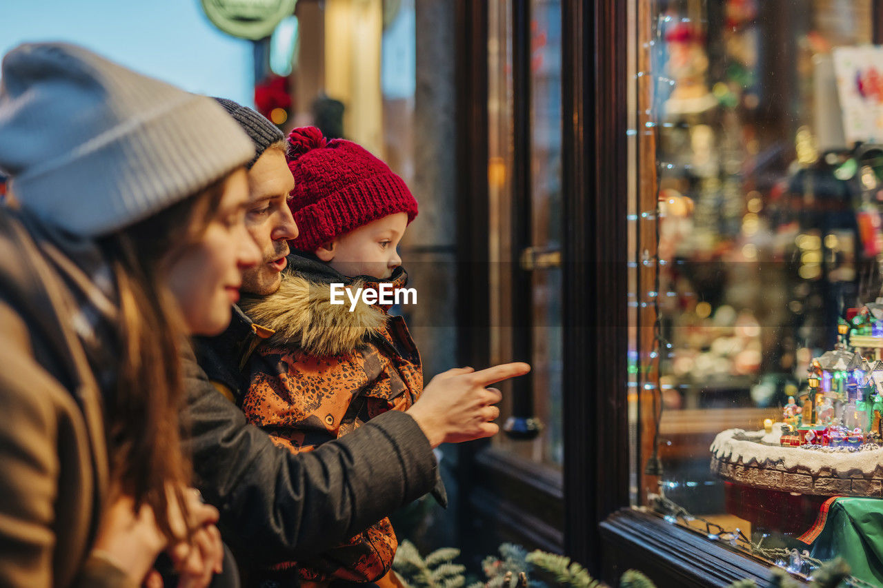 Family window shopping at christmas market