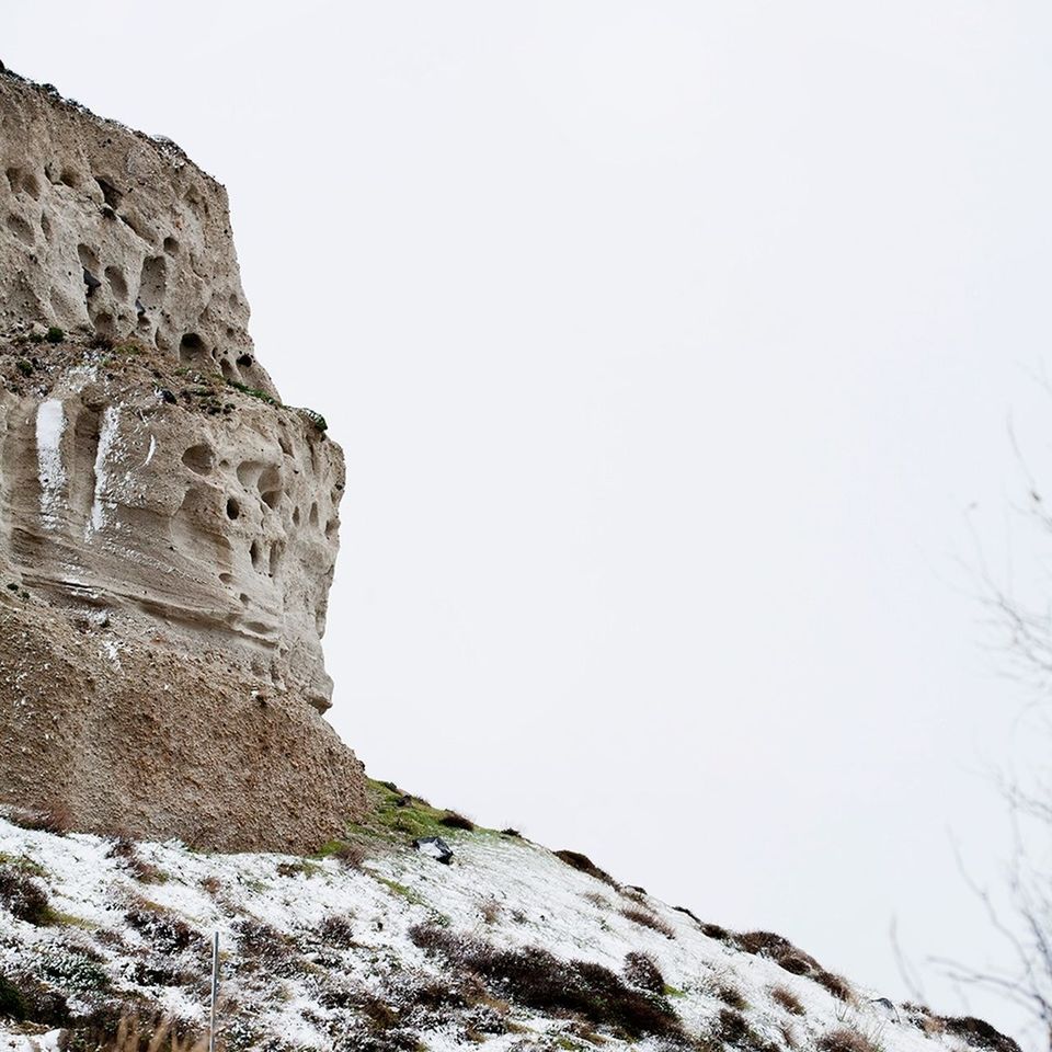 Scenic view of rocky mountain against clear sky during winter