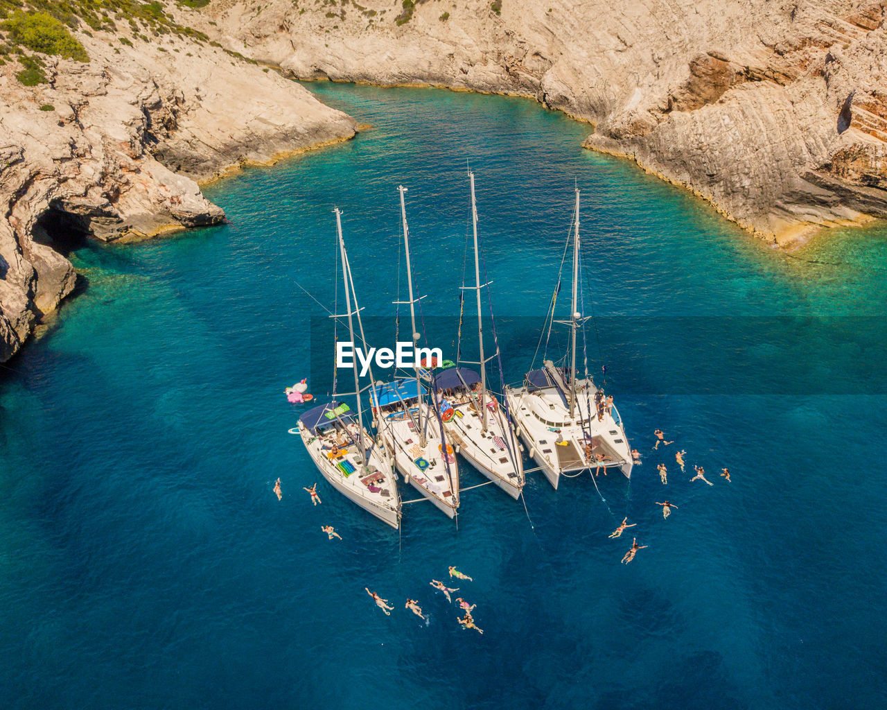 HIGH ANGLE VIEW OF SAILBOAT ON ROCK