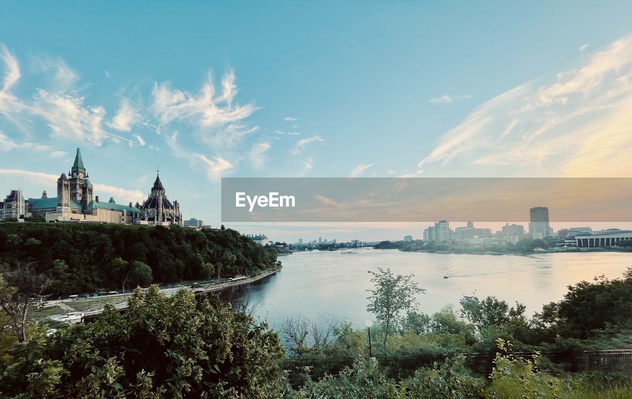 Panoramic view of buildings against cloudy sky. ottawa river, parlement hill canada 